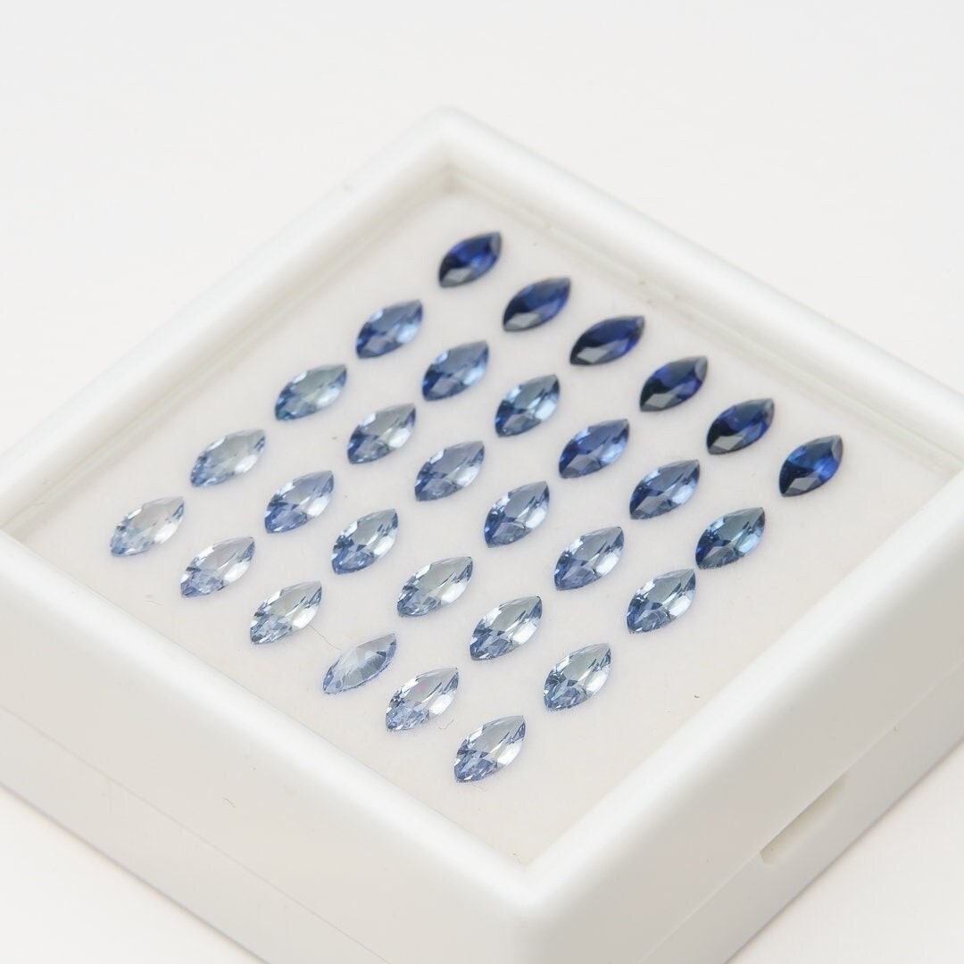 Set of 30 synthetic lab-produced marquise tanzanite gemstones, 3x6mm, blue